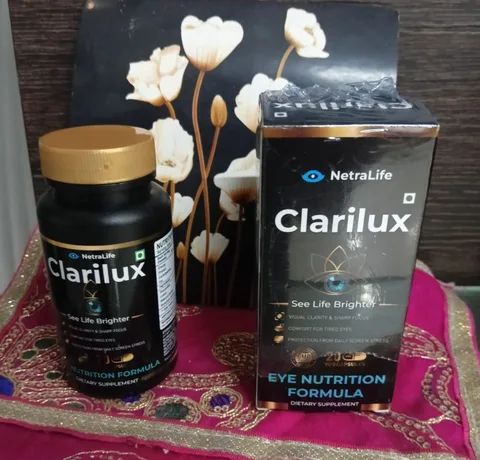 Clarilux bottle and box on a pink cloth