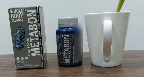 Metabon box and bottle next to a white mug