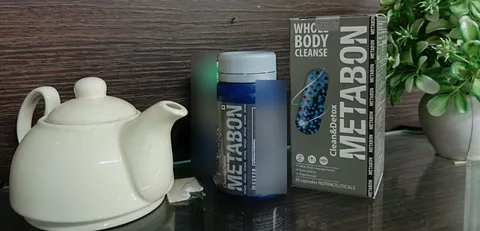 Metabon bottle and box next to a white teapot