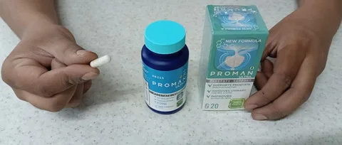 Hands holding a Proman Ultra capsule next to the bottle and box
