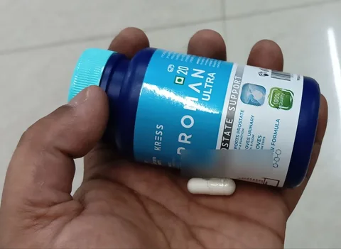 Proman Ultra bottle held in hand with one capsule